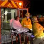 Tangkapan layar dari sebuah video menunjukkan petugas tanggap darurat membantu seseorang masuk ke dalam ambulans di lokasi penembakan di Monterey Park, California, AS [TNLA via Reuters]